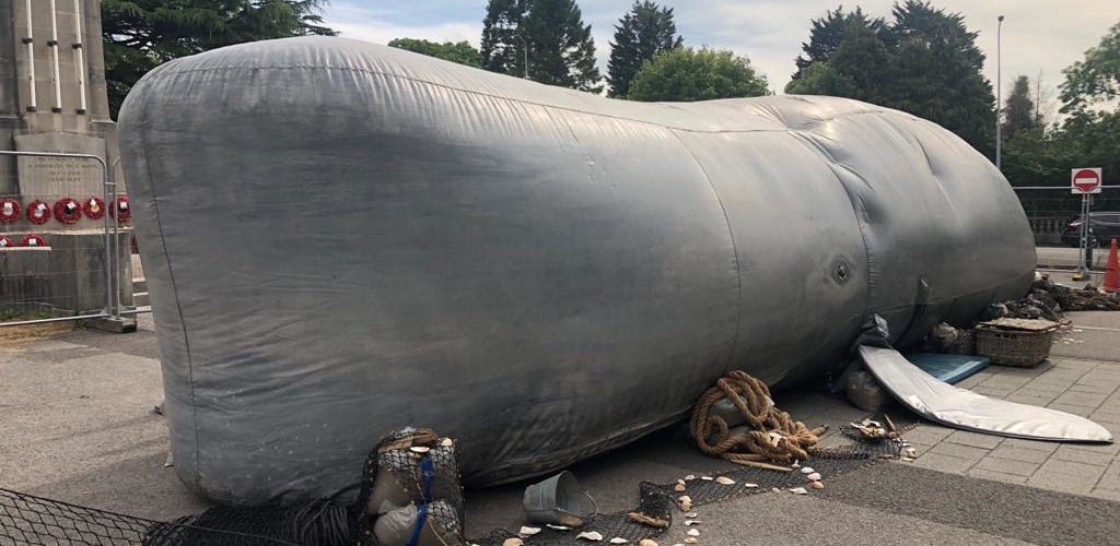 a 30 foot inflatable sperm whale in beached on the Memo carpark